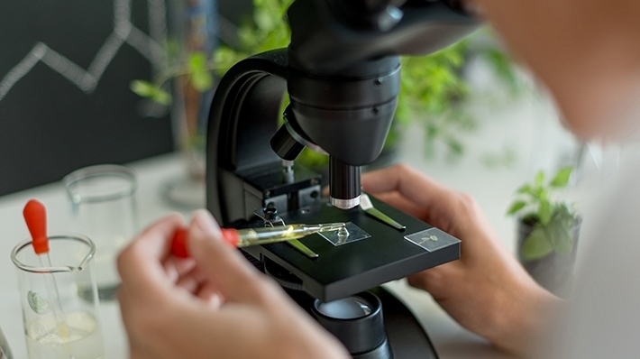 life science image depicting person at microscope
